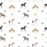 Decorative seamless pattern with unicorns, stars, rainbows in vintage boho style. Wild magic horses for wrapping paper, wallpaper, fabric. Mystical background in pastel colors. Vector illustration