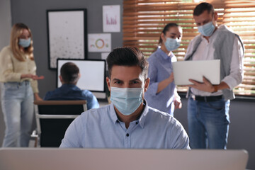 Sticker - Worker with mask in office. Protective measure during COVID-19 pandemic