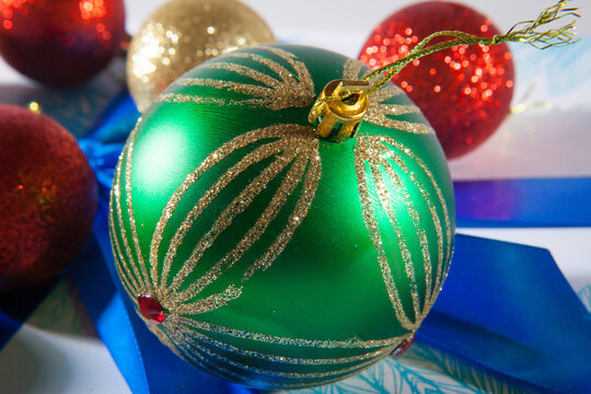Happy Christmas. Multicolored balls on the blue and white gift