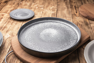 A round concrete plate on a wooden table.