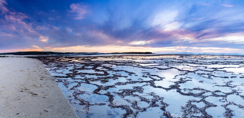 Sticker - beautiful panorama sunset over the ocean with rocky beach and tidal pools in the foreground