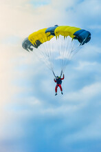 Skydiver On Brightly Colored Parachute After The Jump  Soar High In The Blue Sky	
