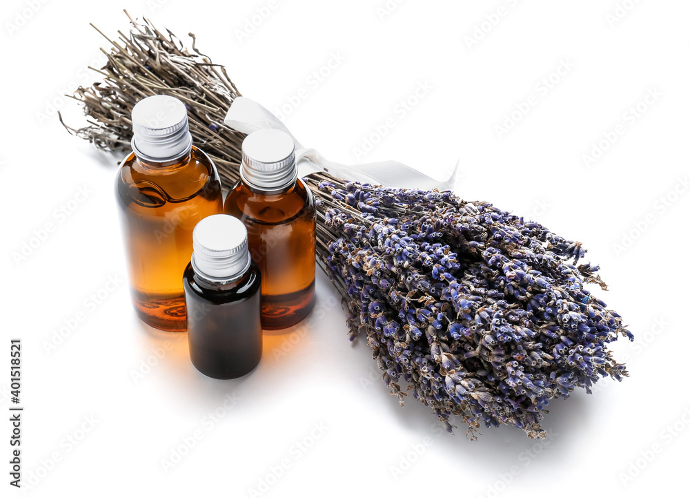 Bottles with lavender essential oil on white background