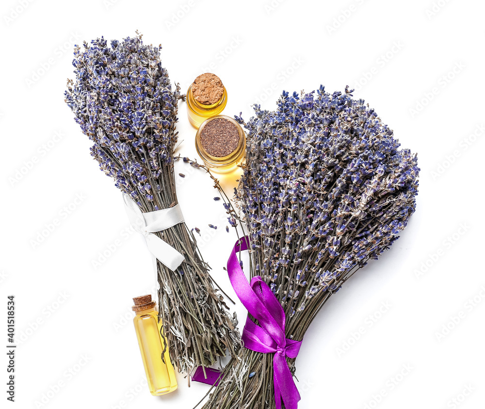 Bottles with lavender essential oil on white background
