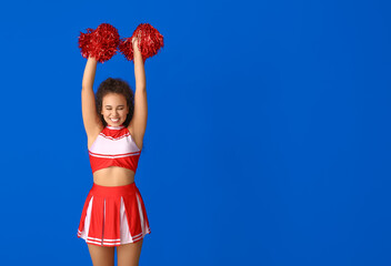 Wall Mural - Beautiful young cheerleader on color background