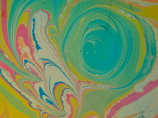 Coloring with liquid acrylic paints. Fluid acrylic art. Mixed liquid paints. Beautiful abstract background. Mixing acrylic paints in water. Photo of the liquid surface in the top view. Colorful textur