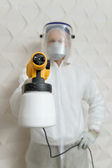 Wall Mural - The painter is painting with a spray gun.