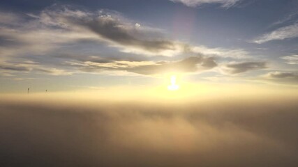 Canvas Print - A drone flies between the clouds during sunrise. Stunning aerial view of orange colored clouds. Atmospheric nature shot.