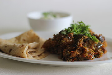 Wall Mural - Brinjal and Potatoes dry curry served along with Indian flat bread