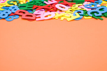 Sticker - A top view closeup of the letters of the English alphabet isolated on an orange background