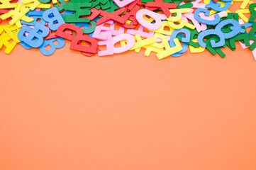 Sticker - A top view closeup of the letters of the English alphabet isolated on an orange background