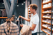 © standret - Looks for jacket. Young guy in modern store with new clothes. Elegant expensive wear for men