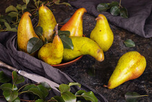 Rural Still Life, Low Key Dark Photography - View Of A Conference Pear In Clay Dishes With Old Knife, Closeup With Selective Focus