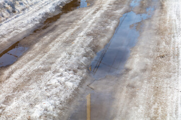 Wall Mural - The road with melting snow in nature.