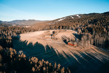 Drone photo shot from the sky. Countryside just outside of Oslo, Norway. Fields and wood mixed together. 