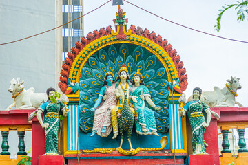 Subramaniam Swamy temple or hindu temple in Saigon (Ho Chi Minh city). Detail of the Trimurti above the entrance of the hindu Temple.