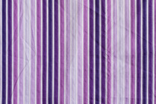 The Texture Of The Fabric In Purple Vertical Stripes.