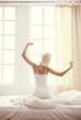 © lenets_tan - Woman stretching in bed after wake up, back view
