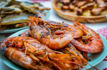 A closeup of deliciously cooked caridean shrimps with spices on a plate on the table