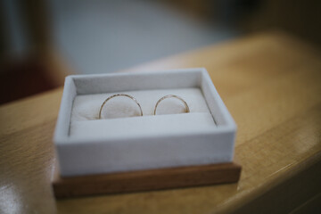 Wall Mural - A macro shot of the gold wedding rings in a box, on a wooden surface