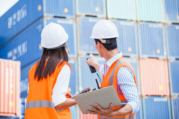 Cargo containers workers of container then use barcode scanner check the product for import and export and work with co-worker women at container yard