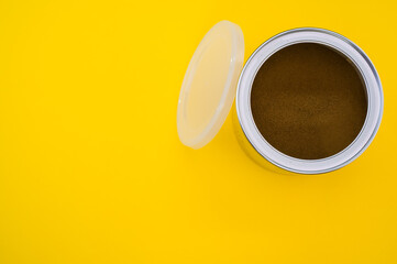 Poster - A top view shot of freshly ground coffee in a can isolated on yellow background