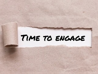 Phrase TIME TO ENGAGE appearing behind torn brown paper.For background purpose.