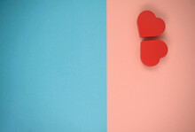 Two Red Hearts On Blue And Pink Background