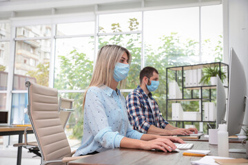 Wall Mural - Office employees in respiratory masks at workplace