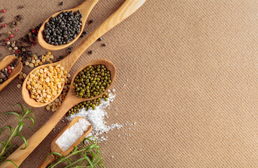 Various raw lentils with rosemary, salt and pepper.