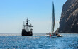 Replica of the historic ship of Christopher Columbus Santa Maria and a pleasure catamaran off the coast of Madeira.
