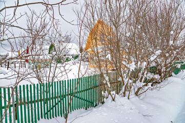 Wall Mural - Real Russian winter, when frost and a lot of snow, in the country village, with small houses, roads through high snowdrifts