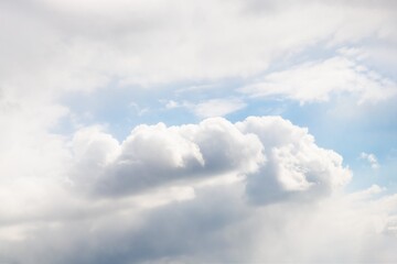 Wall Mural - White fluffy clouds in light blue sky