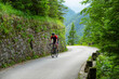Professional road cyclist rides up a challenging mountain road in Slovenia.