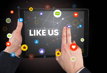 Close-up of a touchscreen with LIKE US inscription, social networking concept