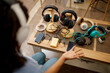 © Nomad_Soul - Woman choosing headphones in speaker systems store
