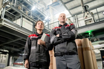 Aufkleber - Confident male and female engineers of large factory standing in front of camera