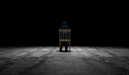 Man Sitting on Wooden Chair on concrete floor with light effect