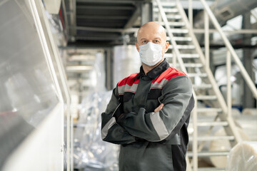 Aufkleber - Bald mature worker of polymer processing factory in workwear and protective mask