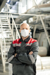 Aufkleber - Bald mature worker in uniform and protective mask crossing arms by chest