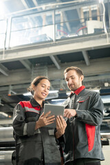 Poster - Young quality control managers of contemporary factory scrolling through data