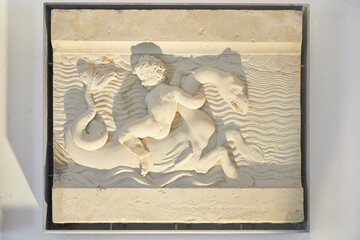 Sticker - Nice little reliefs with putti and sea monsters.