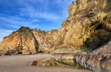 Wall Mural - Cliffs and caves at Hug Point, Arch Cape, Oregon. The old road carved out of the cliff starts on the right