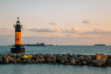 Wall Mural - Sunset of Songdo beach, lighthouse and breakwater in Busan, Korea