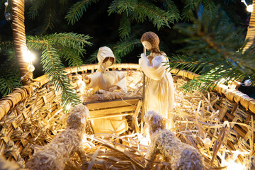 Baby Jesus resting on a manger with light from the star filters through window