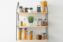 Set Of Jars With Products On Kitchen Shelves