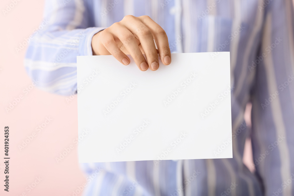 Woman with blank paper sheet on color background