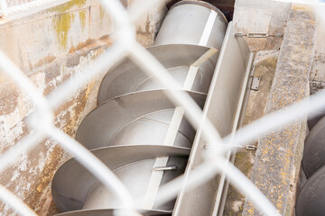 Poster - A screw conveyor at a sewage treatment plant