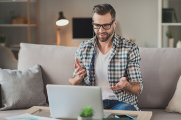 Photo of young handsome man happy positive smile speak call talk videocall meeting distance work workshop indoors