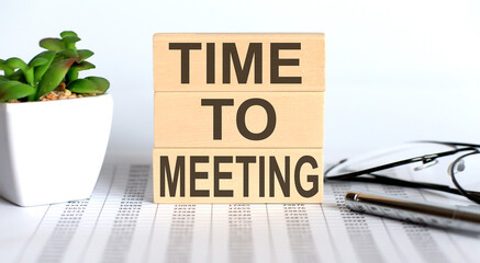 Poster - TIME TO MEETING text on the wooden cubes on the chart